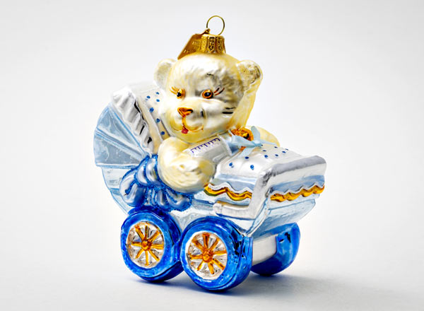 Christmas tree toy Teddy bear in a blue baby stroller