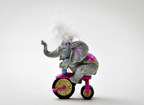 Christmas tree toy A circus elephant on a bicycle