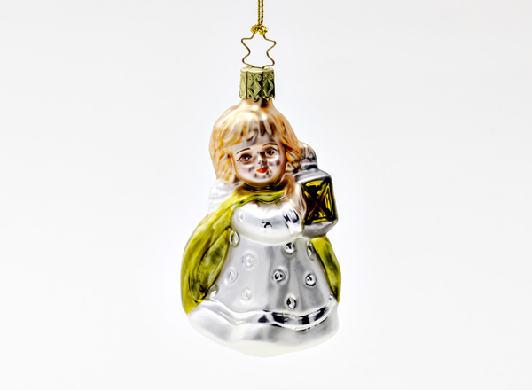 Christmas tree toy Girl with a flashlight in a white dress